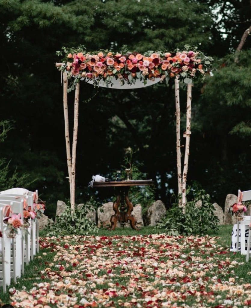 Birchwood wedding arch with florals for fall wedding ceremony