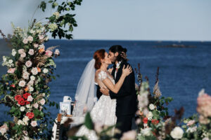 Bride and Groom kissing at outdoor wedding ceremony in Boston